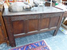 AN 18th C. OAK COFFER WITH BLIND FRET CARVING ABOVE THE FOUR PANELLED FRONT. W 136 x D 53 x H