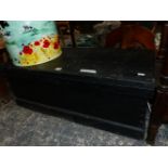 A BLACK PAINTED WOODEN TRUNK. W 94 x D 41 x H 36cms.