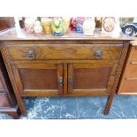 A 20th C. OAK WASHSTAND WITH A DRAWER OVER DOORS BETWEEN CHANELLED LEGS. W 92 x D 45 x H 78cms.