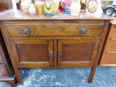 A 20th C. OAK WASHSTAND WITH A DRAWER OVER DOORS BETWEEN CHANELLED LEGS. W 92 x D 45 x H 78cms.