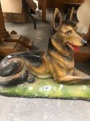 A COLD PAINTED FIGURE OF A RECLINING ALSATIAN