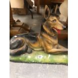 A COLD PAINTED FIGURE OF A RECLINING ALSATIAN