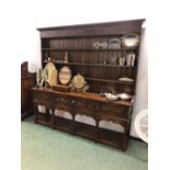 A LARGE 18th C. STYLE OAK POT BOARD DRESSER BASE AND ASSOCIATED PLATE RACK.