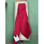 A LOUIS VUITTON RED SILK TIE.