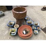 A PLANTER ON MATCHING STAND IN THE FORM OF A TREE TRUNK TOGETHER WITH VARIOUS OTHER PLANT POTS.