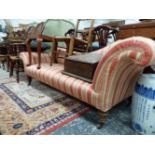 A VICTORIAN CHAISE LONGUE UPHOLSTERED IN TERRACOTTA STRIPED MATERIAL ON TURNED MAHOGANY LEGS WITH