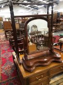 A ROUND ARCH DRESSING TABLE MIRROR IN A MAHOGANY FRAME TOGETHER WITH A MAHOGANY TOWEL RAIL