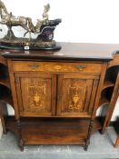 AN EDWARDIAN MARQUETRIED ROSEWOOD SIDE CABINET, THE CENTRAL VASE INLAID DRAWER OVER DOORS AND A