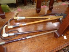 FOUR ANTIQUE RIDING CROPS INC. SILVER MOUNTED EXAMPLE.