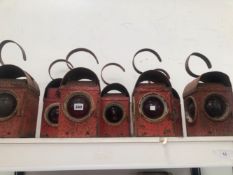 SEVEN RED PAINTED RAILWAY LANTERNS