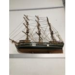 A MODEL THREE MASTED SHIP WITH ROPE RIGGING