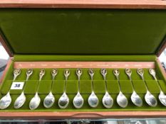 A SET OF TWELVE SILVER HALLMARKED CASED SPOONS, THE ROYAL HORTICULTURAL SOCIETY FLOWER SPOONS