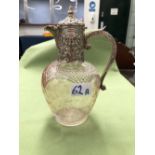 A HALLMARKED SILVER MOUNTED CUT GLASS CLARET JUG.