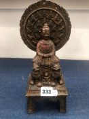 A CHINESE BRONZE FIGURE OF THE BUDDHA ENTHRONED ABOVE TWO LIONS. H 31cms.