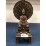 A CHINESE BRONZE FIGURE OF THE BUDDHA ENTHRONED ABOVE TWO LIONS. H 31cms.