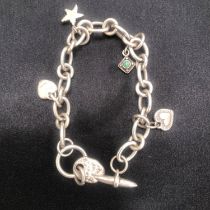 A SILVER CHARM BRACELET WITH CHARMS.