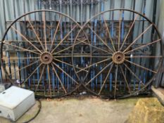 A PAIR OF LARGE VINTAGE IRON CART WHEELS