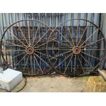 A PAIR OF LARGE VINTAGE IRON CART WHEELS