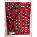TWO SMALL ORIENTAL RUGS OF BOKHARA DESIGN. LARGEST 180 x 65cms (2)