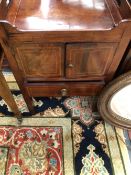 A GEORGE III MAHOGANY NIGHT TABLE WITH HANDLES PIERCED INTO THE GALLERIED TOP OVER SATIN WOOD BANDED