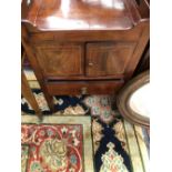 A GEORGE III MAHOGANY NIGHT TABLE WITH HANDLES PIERCED INTO THE GALLERIED TOP OVER SATIN WOOD BANDED