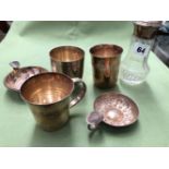 TWO FRENCH SILVER TUMBLER BEAKERS, TWO SILVER PLATED WINE TASTERS, AND A SILVER MOUNTED SIFTER.