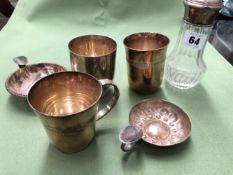 TWO FRENCH SILVER TUMBLER BEAKERS, TWO SILVER PLATED WINE TASTERS, AND A SILVER MOUNTED SIFTER.