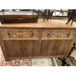 AN EARLY 20th C. OAK SIDEBOARD WITH WROUGHT IRON BACK TO THE RECTANGULAR TOP OVER TWO DRAWERS WITH