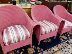 THREE PINK PAINTED LLOYD LOOM ARMCHAIRS WITH STRIPED CUSHION SEATS