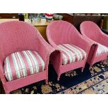 THREE PINK PAINTED LLOYD LOOM ARMCHAIRS WITH STRIPED CUSHION SEATS