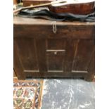 A LARGE OAK TRUNK OR COFFER, THE HINGED LID OVER AN INTERIOR HELD BY A CENTRAL IRON BAR. W 120 x D