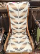 A 19th C. WALNUT SHOW FRAME ROCKING CHAIR WITH A TALL UPHOLSTERED BACK,SCROLLING ARMS AND BALUSTER