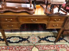 A 20th C. MAHOGANY TABLE WITH A CONFIGURATION OF FIVE DRAWERS, THE SQUARE LEGS TAPERING TO CERAMIC