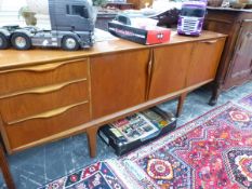 A 20th C. RETRO TEAK SIDE BOARD, THE CENTRAL DRAWER FLANKED ON ONE SIDE BY THREE DRAWERS AND ON THE