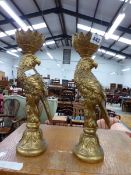 A PAIR OF PARROT GILDED CANDLESTICKS.