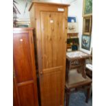 A PINE CUPBOARD, THE DOOR ENCLOSING SELVES. W 47 x D 54 x H 179cms.