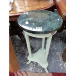 A GREEN MARBLE TOPPED PAINTED WOOD THREE LEGGED PLANTER STAND. Dia 30 x H 75cms.