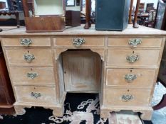 A 20th C. PINE PEDESTAL DESK, THE CENTRAL KNEEHOLE DRAWER ABOVE A RECESSED CUPBOARD AND FLANKED BY