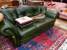 A GREEN LEATHERETTE UPHOLSTERED THREE SEAT SETTEE