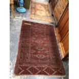 AN ANTIQUE TEKKE BOKHARA RUG. 165 x 107cms. TOGTHER WITH A MACHINE MADE RUG OF CAUCASIAN DESIGN (2)