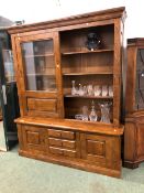 A LARGE BESPOKE GLAZED OAK BOOKCASE WITH SLIDING UPPER DOORS. 211 X 176 X 51cms.