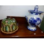 A MAJOLICA CHEESE BELL AND A BLUE AND WHITE URN.