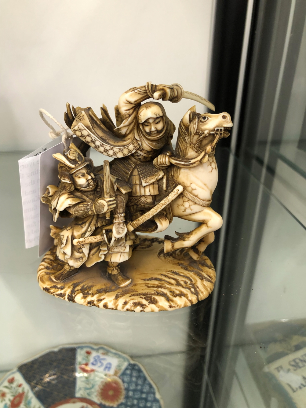 AN IVORY OKIMONO CARVED AS WARRIORS FIGHTING
