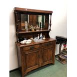 AN OAK MIRROR BACK SIDEBOARD.