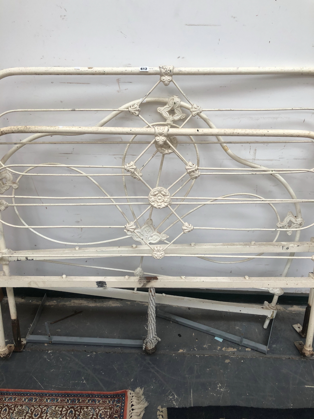 A PAIR OF WHITE PAINTED IRON DOUBLE BED HEADS TOGETHER WITH A SINGLE HEAD BOARD.