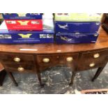 A GEORGE III MAHOGANY BOW FRONT SIDEBOARD, THE CENTRAL DRAWER FLANKED BY TWO ON ONE SIDE AND A