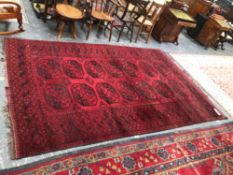 AN AFGHAN SMALL CARPET. 310 x 204cms