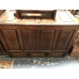 AN 18th C. OAK MULE CHEST, THE FOUR PANELLED FRONT ABOVE THREE DRAWERS. W 124 x D 58 x H 86.5cms.