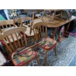 A SET OF SIX PINE KITCHEN CHAIRS, A PAINE ROCKING CHAIR AND A PINE DINING TABLE. W 179 x D 89 x H
