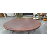 A 19th C. MAHOGANY OVAL TABLE WITH LEATHER INSET TOP AND ON TWO OCTAGONAL COLUMNS EACH WITH FOUR